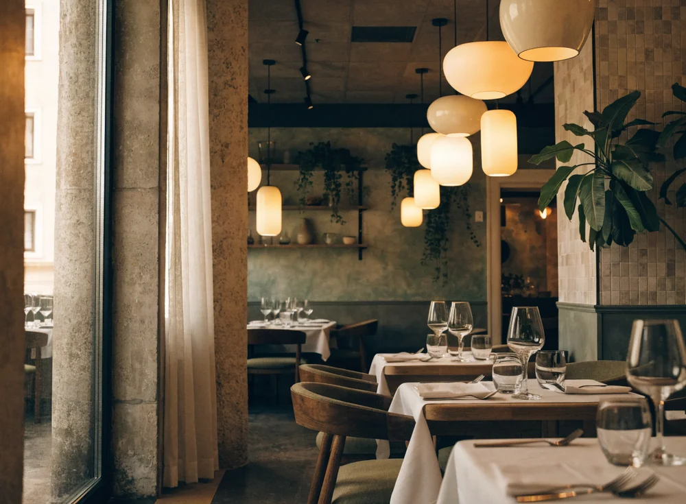 A warm, inviting restaurant interior with set tables